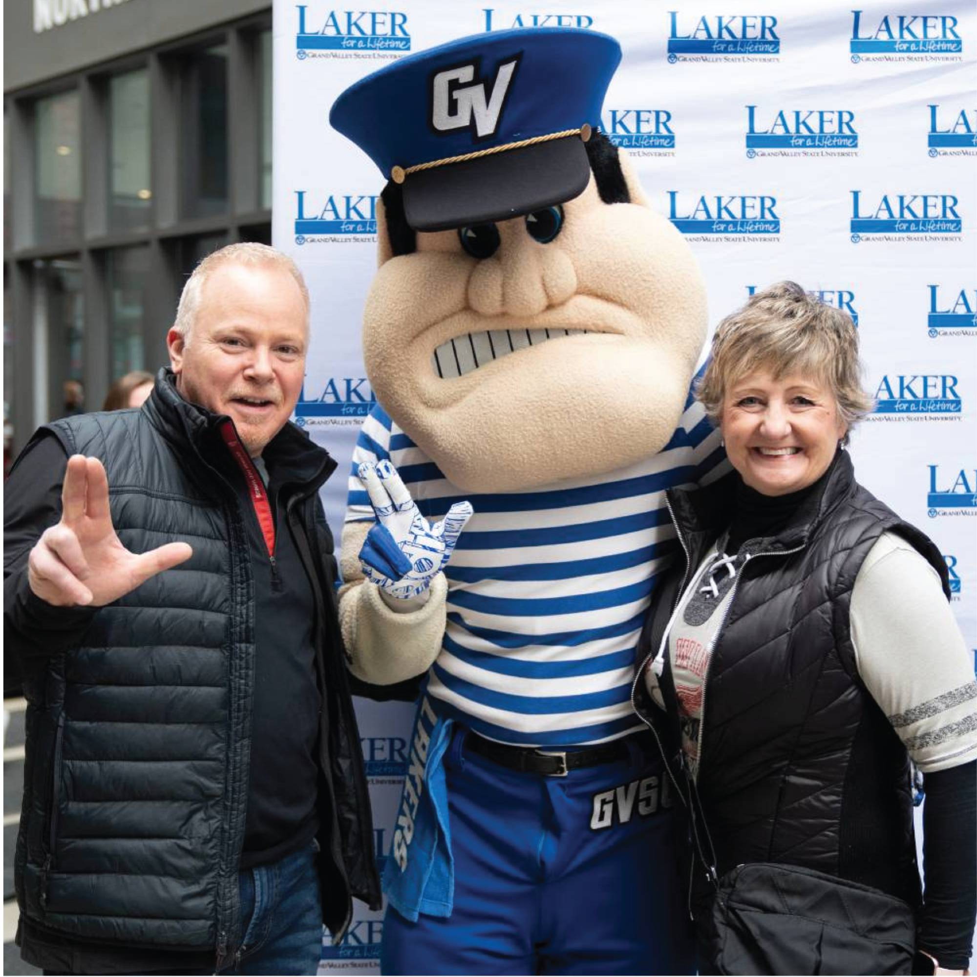 A photo of 2 alumni with Louie the Laker at the GVSU Red Wings Night